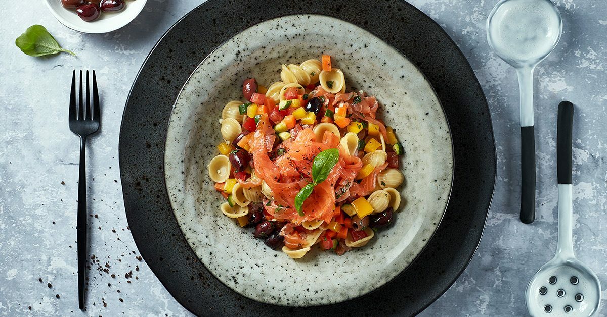 Insalata di pasta con salmone affumicato e verdure miste.